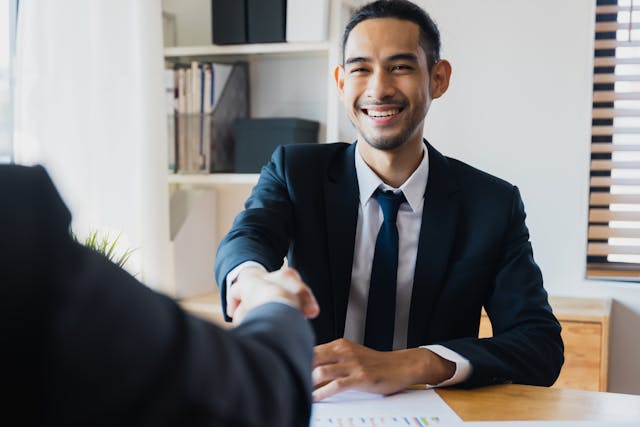 bank teller shaking hands with client